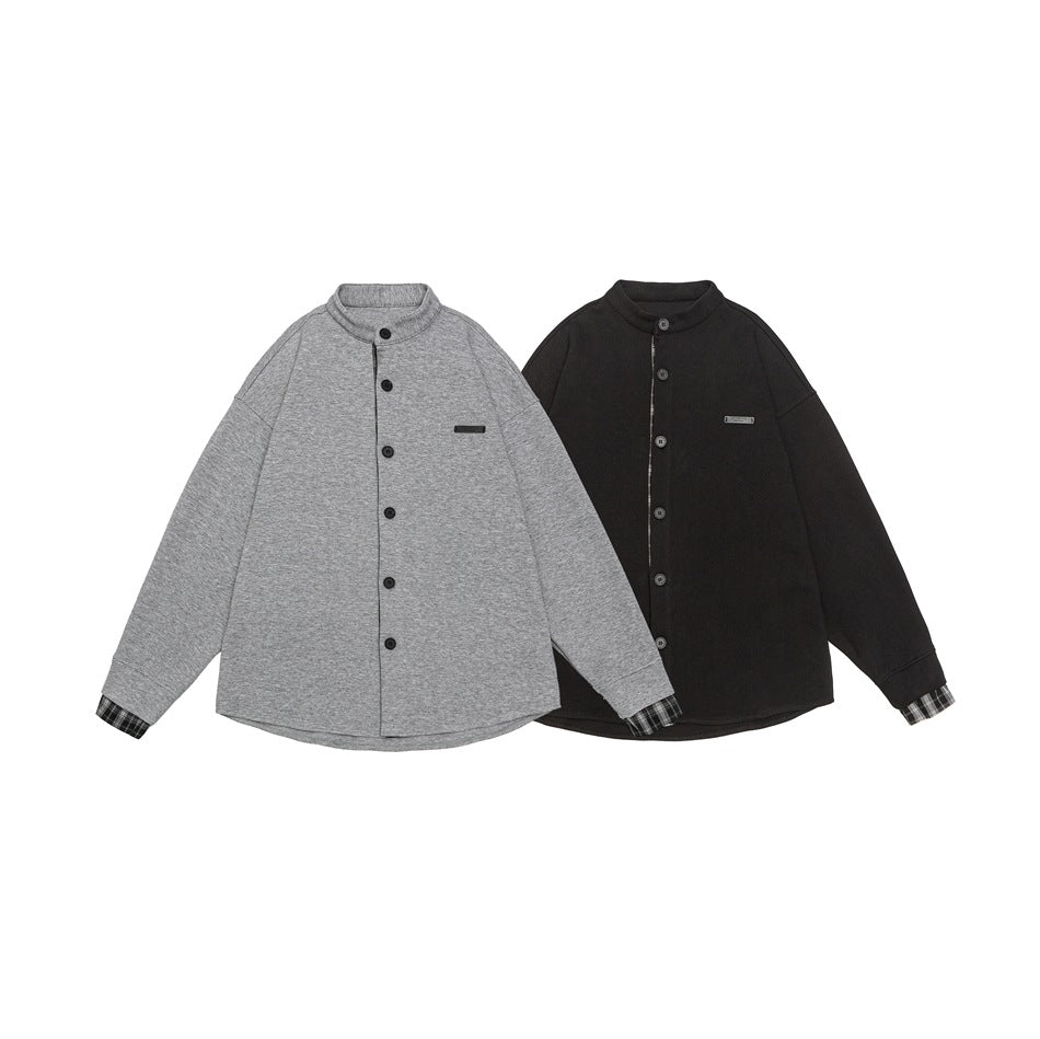 Front views of two button-front stand-collar jackets, one light gray and one black, with plaid cuffs.