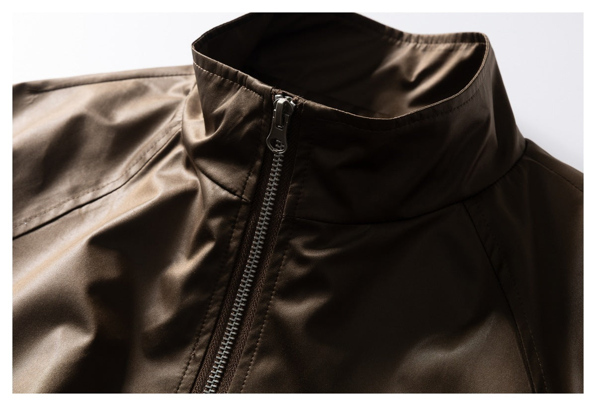 Close-up of the jacket's stand collar and upper front zipper in glossy dark brown fabric.