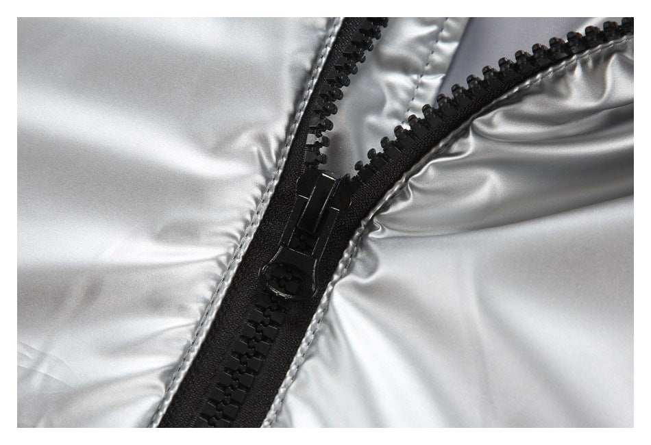 Close-up of a chunky black zipper and pull against shiny silver outerwear.