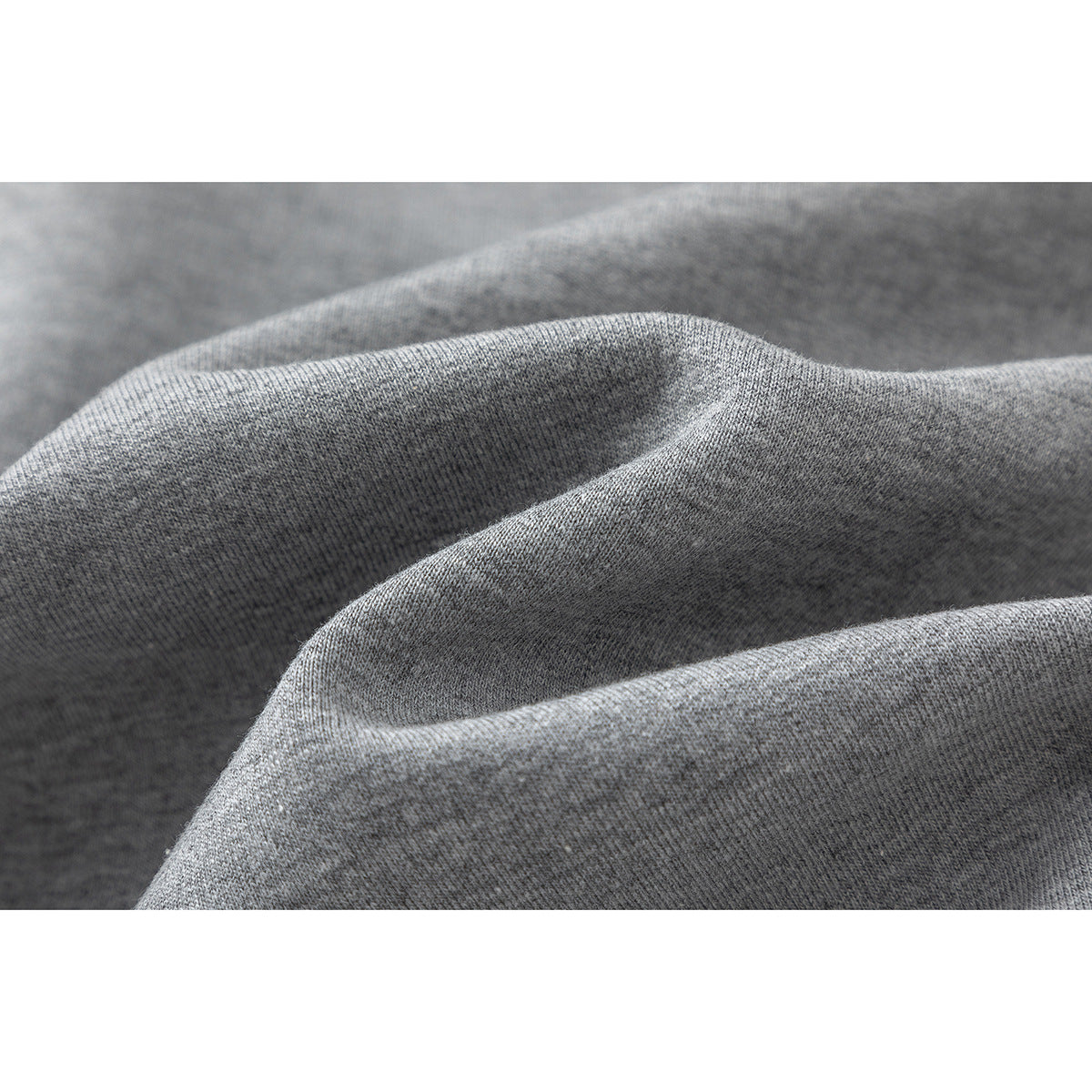 Close-up of heather gray knit fabric draped into soft folds.