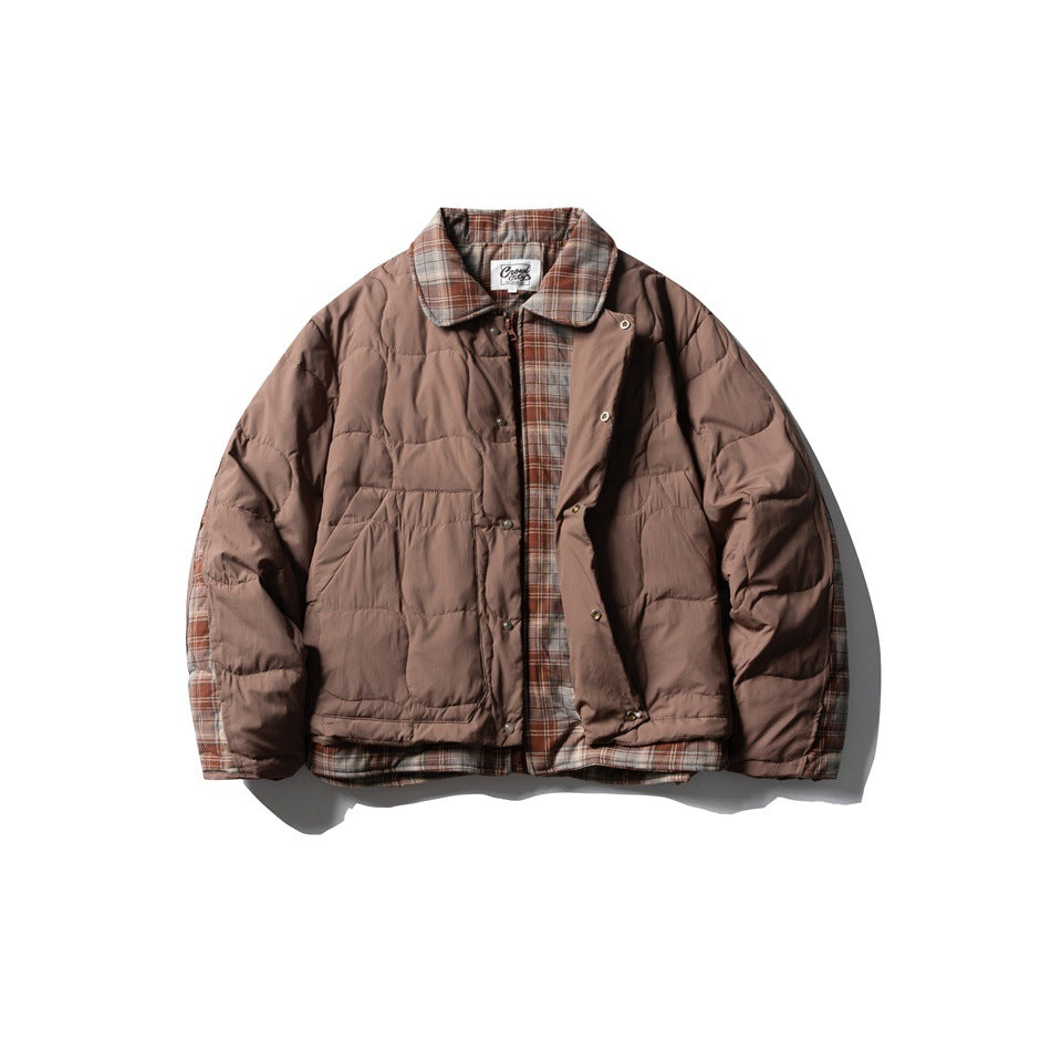 Front view of a brown quilted jacket with a plaid collar, lining, and hem trim, laid flat.