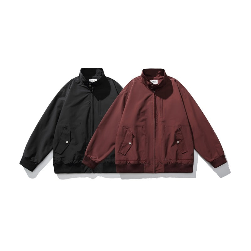 Black and burgundy jackets shown from the front, with stand collars, zip closures, flap pockets and ribbed cuffs and hems.