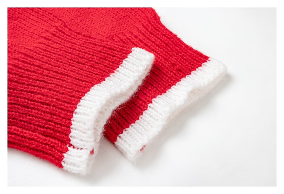 Close-up of a red knitted garment edge with thick white ribbed trim.