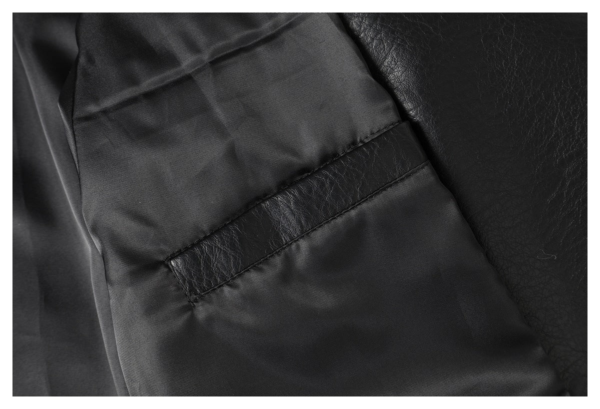 Close-up of the black jacket's smooth dark lining and a stitched strip of outer material.