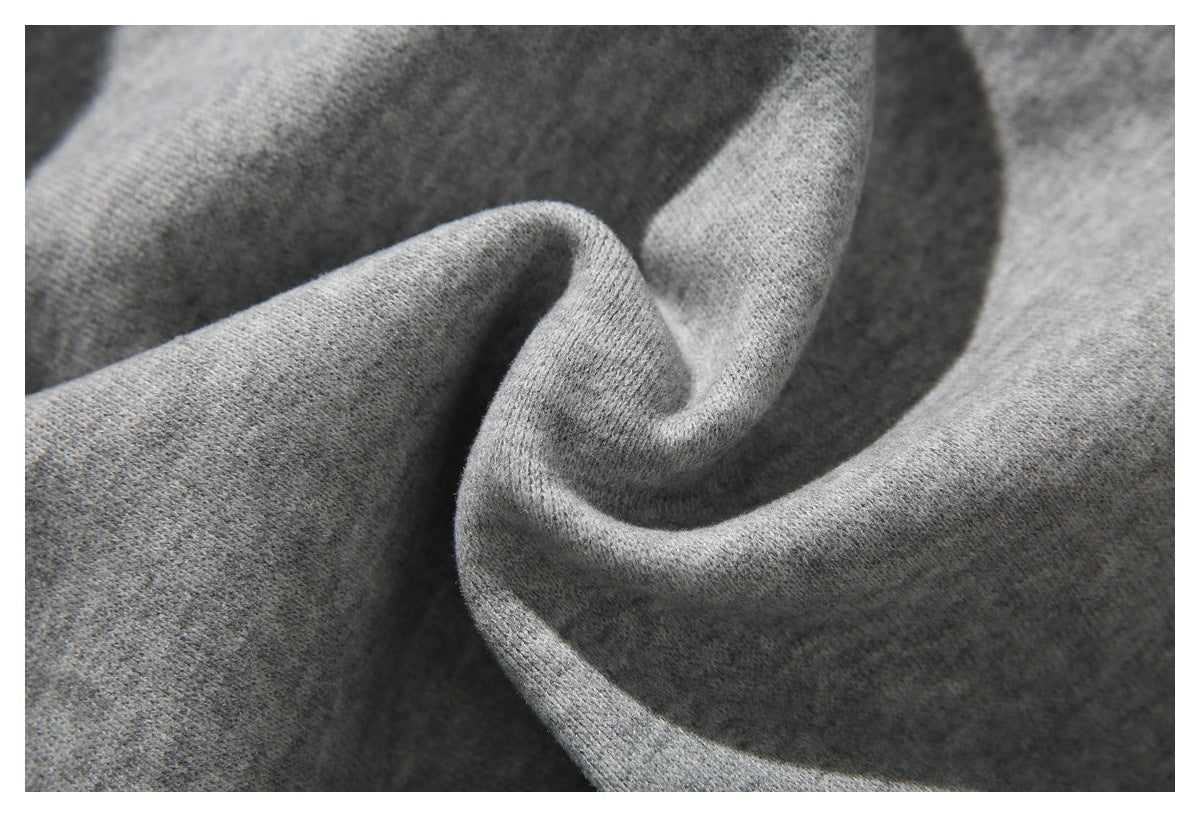 Close-up of gray knit fabric arranged in soft folds.