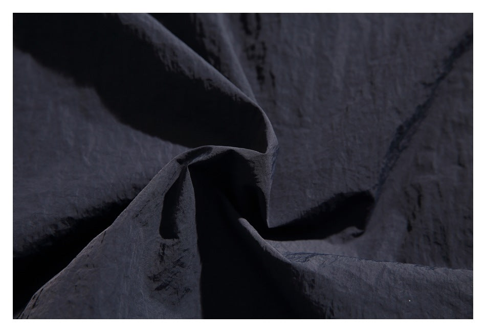 Close-up showing the crinkled texture of dark navy fabric.