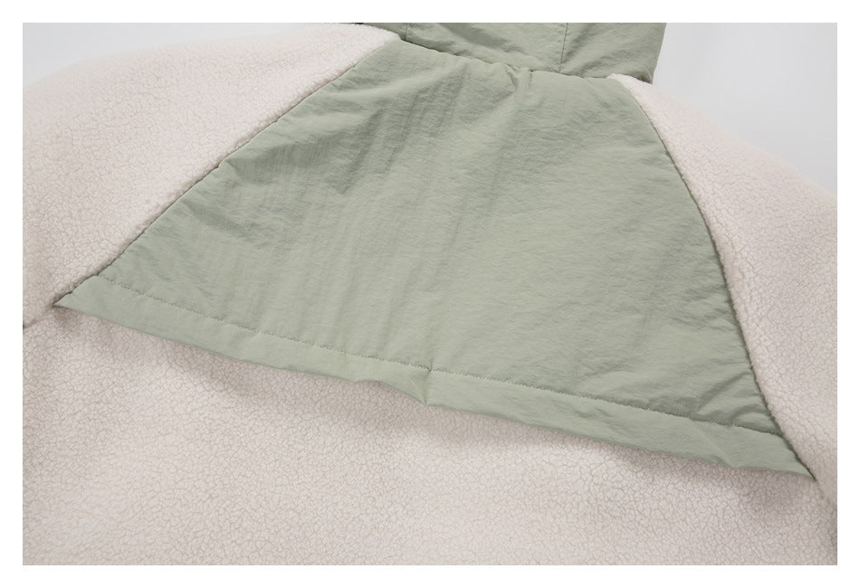 Close-up of the sage green jacket's back panel and cream sherpa side panels.