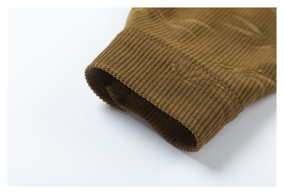 Close-up of the open cuff of a brown corduroy shirt, showing thick ribs and a subtle woven pattern.