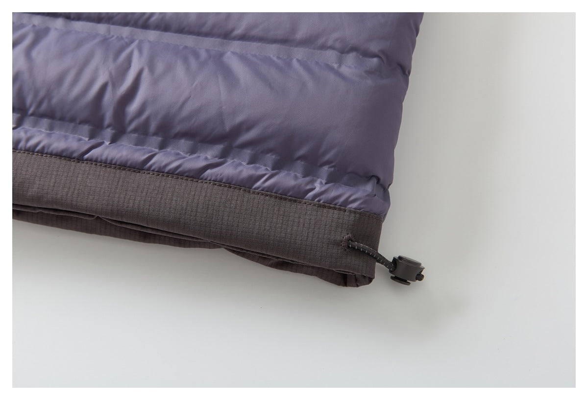 Close-up of the jacket hem, showing a dark contrast band and adjustable cord toggle.