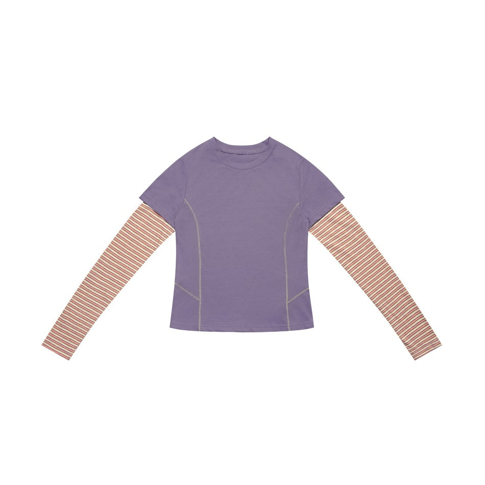 Purple layered-look top with light stitching and orange-cream striped long sleeves, flat lay