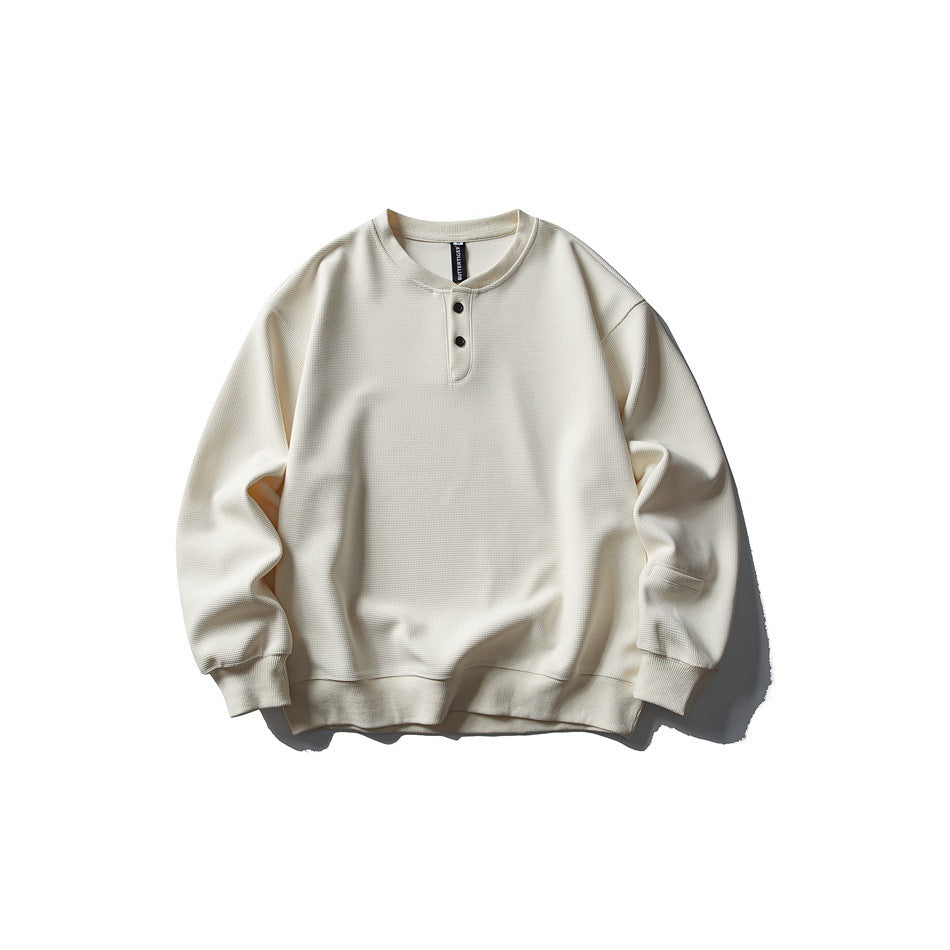 Front view of an ivory long-sleeve sweatshirt with a two-button henley neckline, ribbed cuffs and hem.