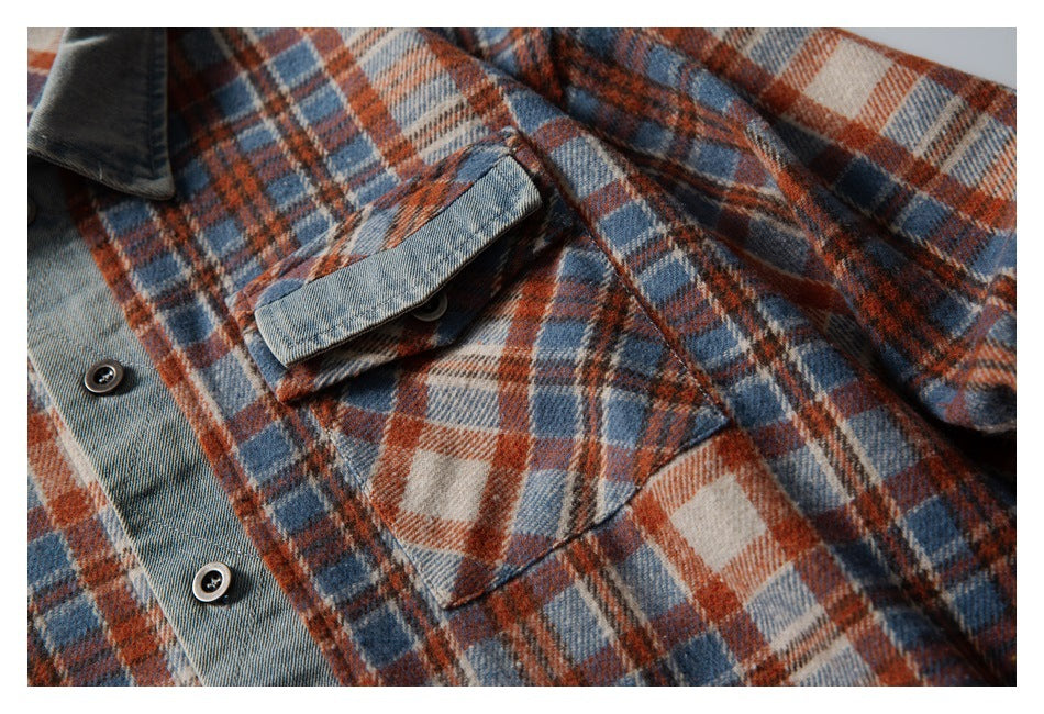 Close-up of the plaid shirt's chest pocket and flap, with a gray denim-style button placket.