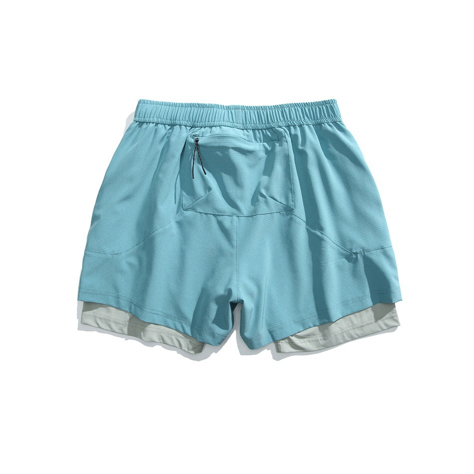 Light blue athletic shorts with an elastic waistband, zippered front pocket, curved seams and a visible light inner layer.