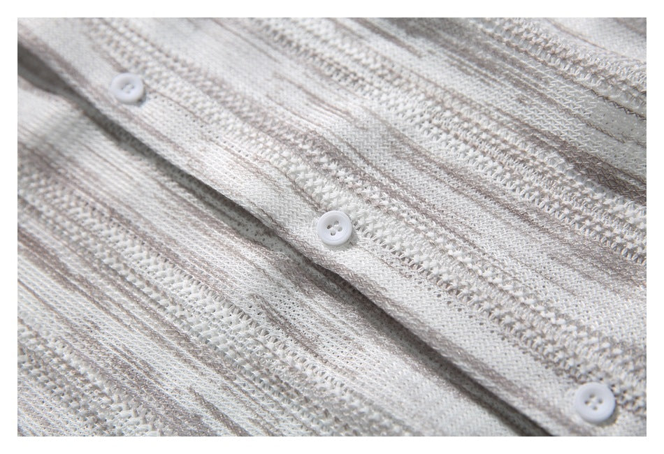 Close-up of white buttons and placket against the ivory and taupe striped openwork knit.