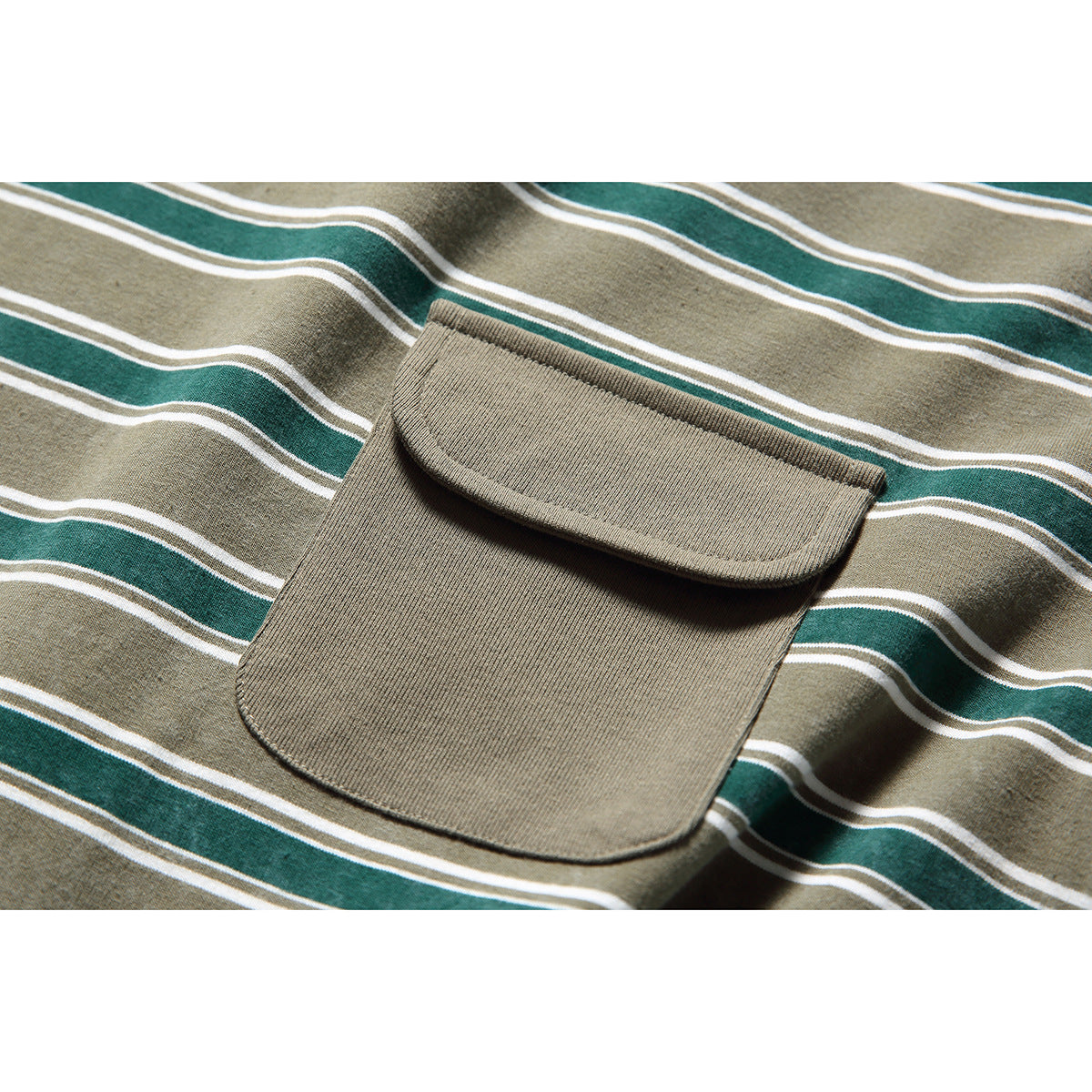 Close-up of a large khaki chest pocket with a rounded flap on a green and white striped T-shirt.