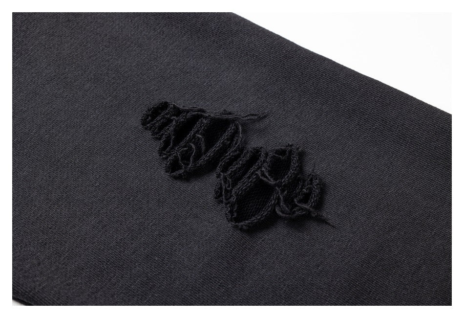 Close-up of black fabric with a raised, frayed black design.