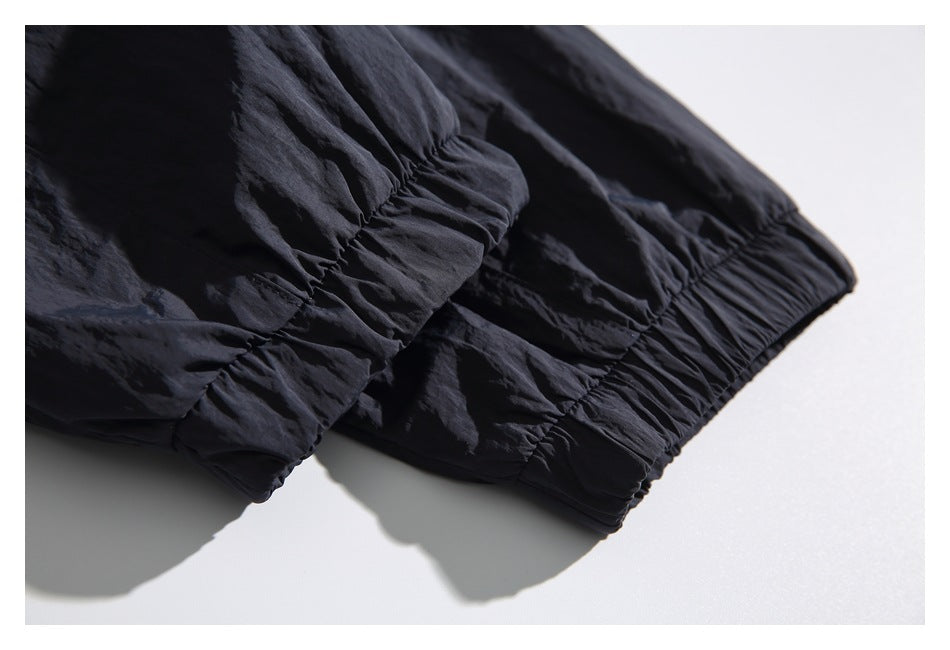 Close-up of a dark navy garment's gathered elastic cuff and hem.