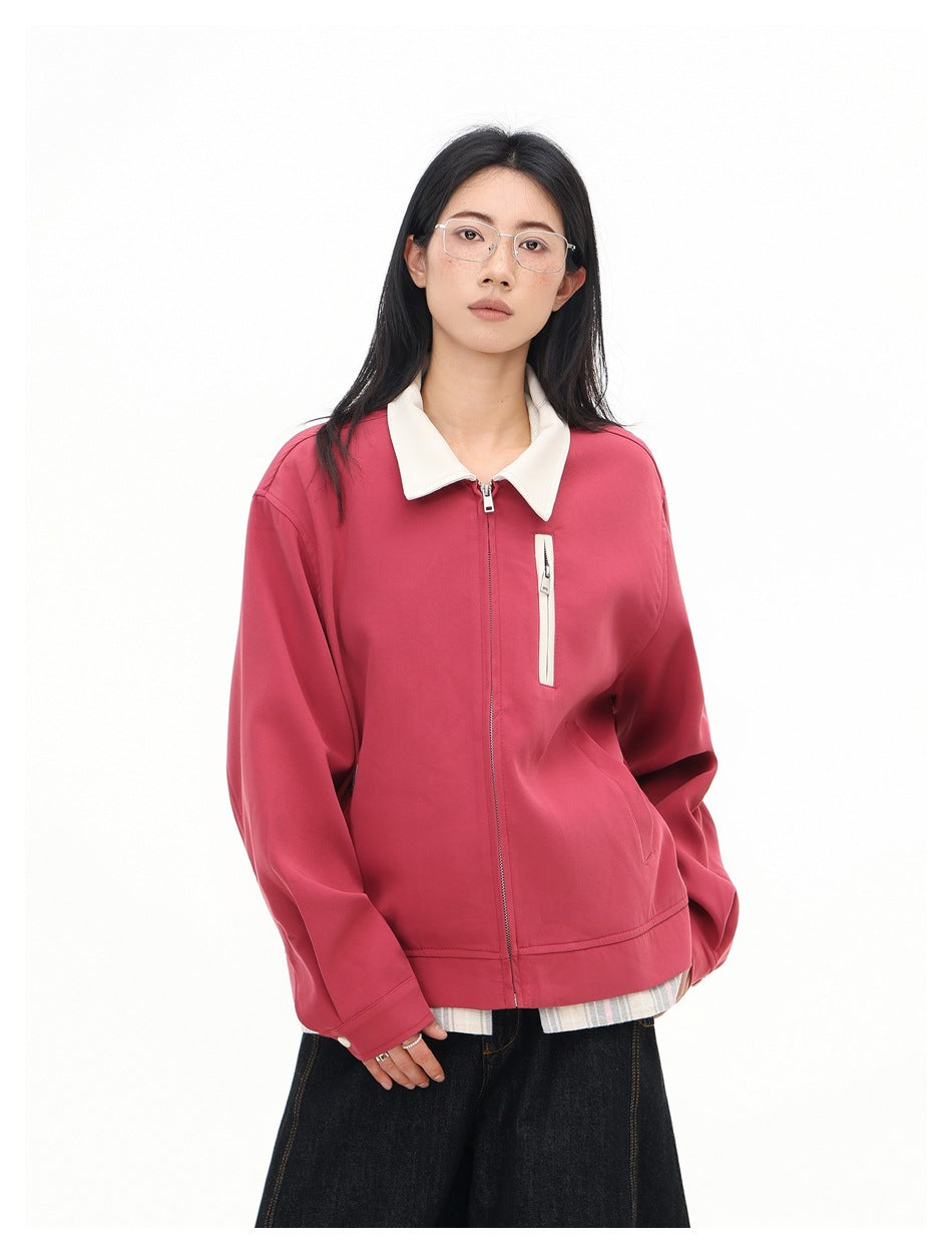 Closer front view of a model wearing a rose-pink zip jacket with a cream collar and chest pocket.