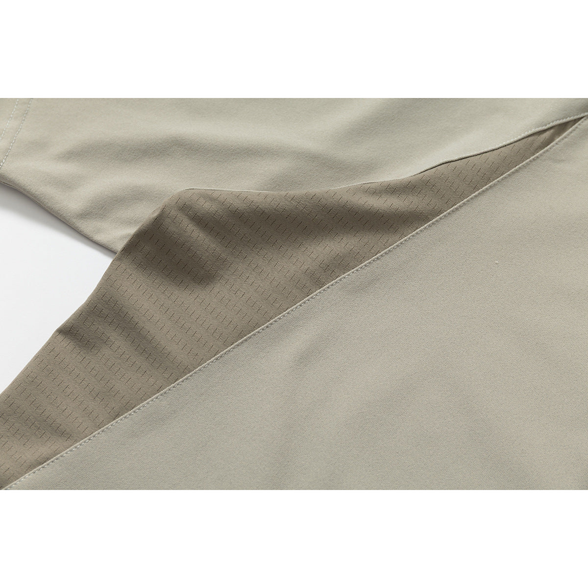 Close-up of the taupe shirt's interior patterned underarm panel and adjoining seam.
