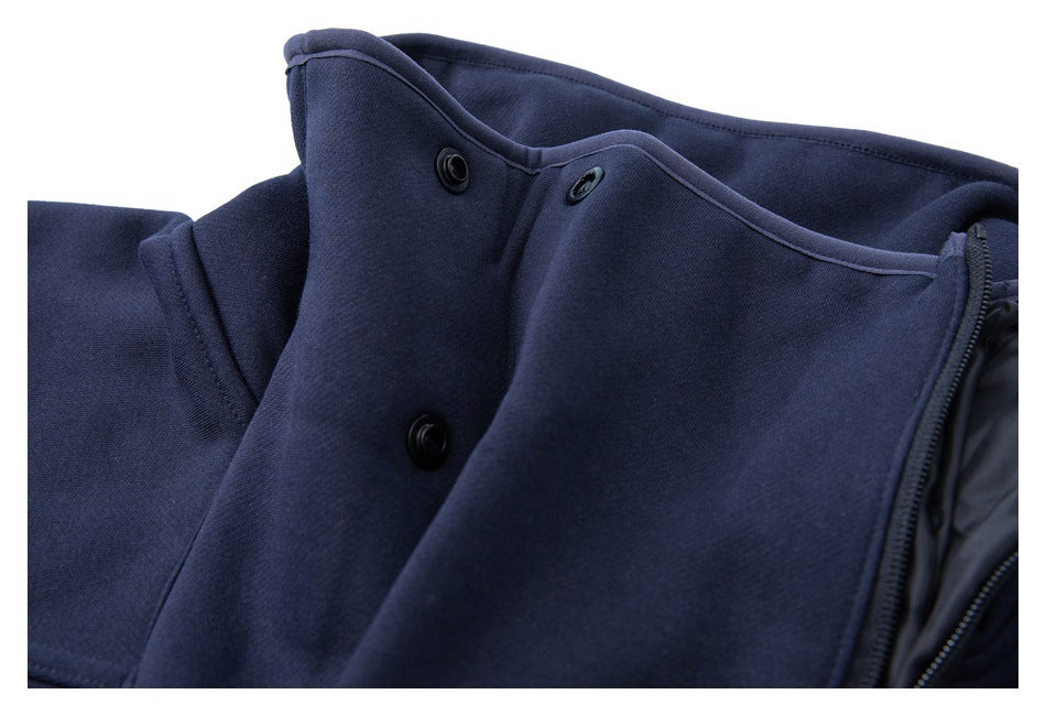 Close-up of the navy pullover's collar edge and black snap buttons.