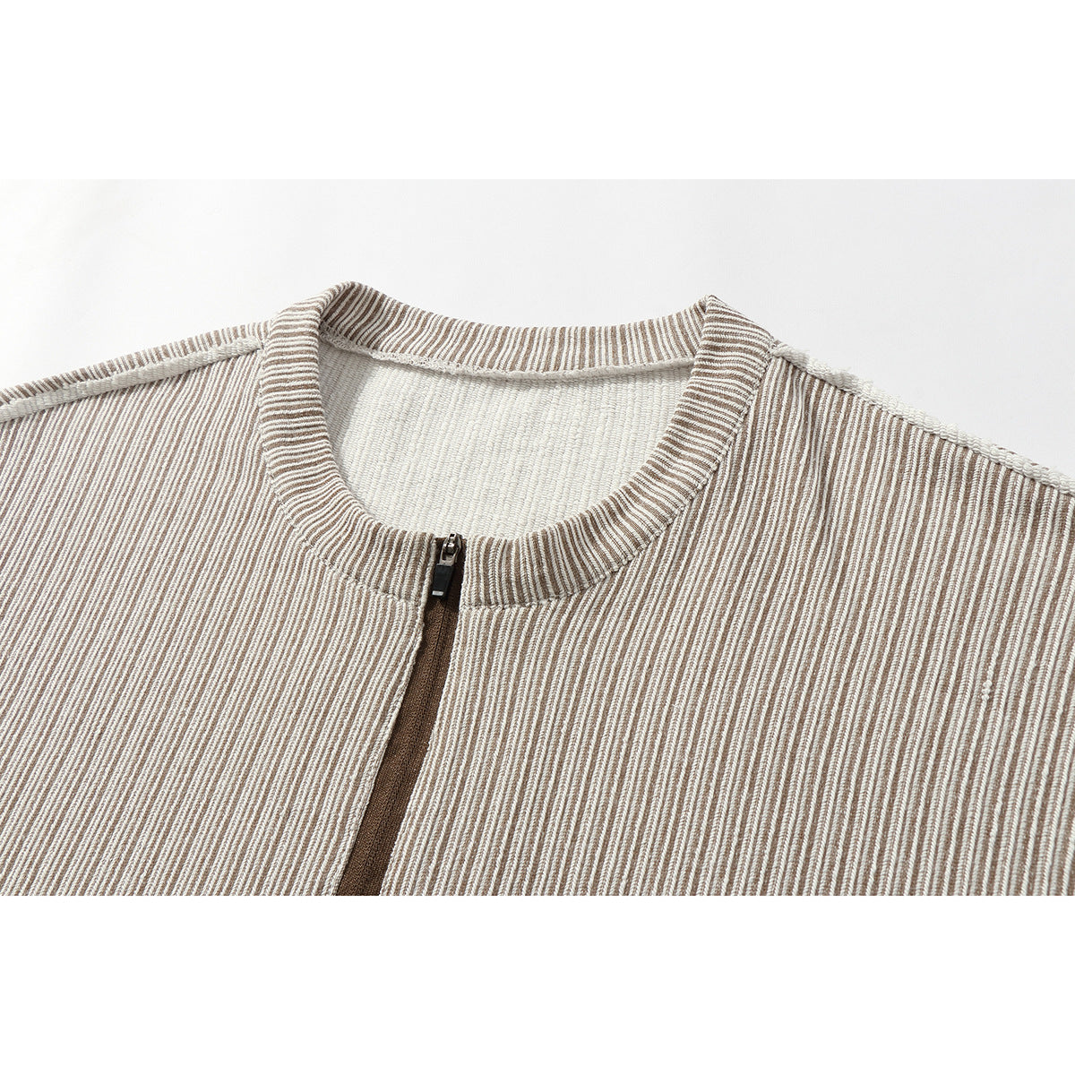 Close-up of a beige and brown striped garment with a ribbed round collar and front zipper.