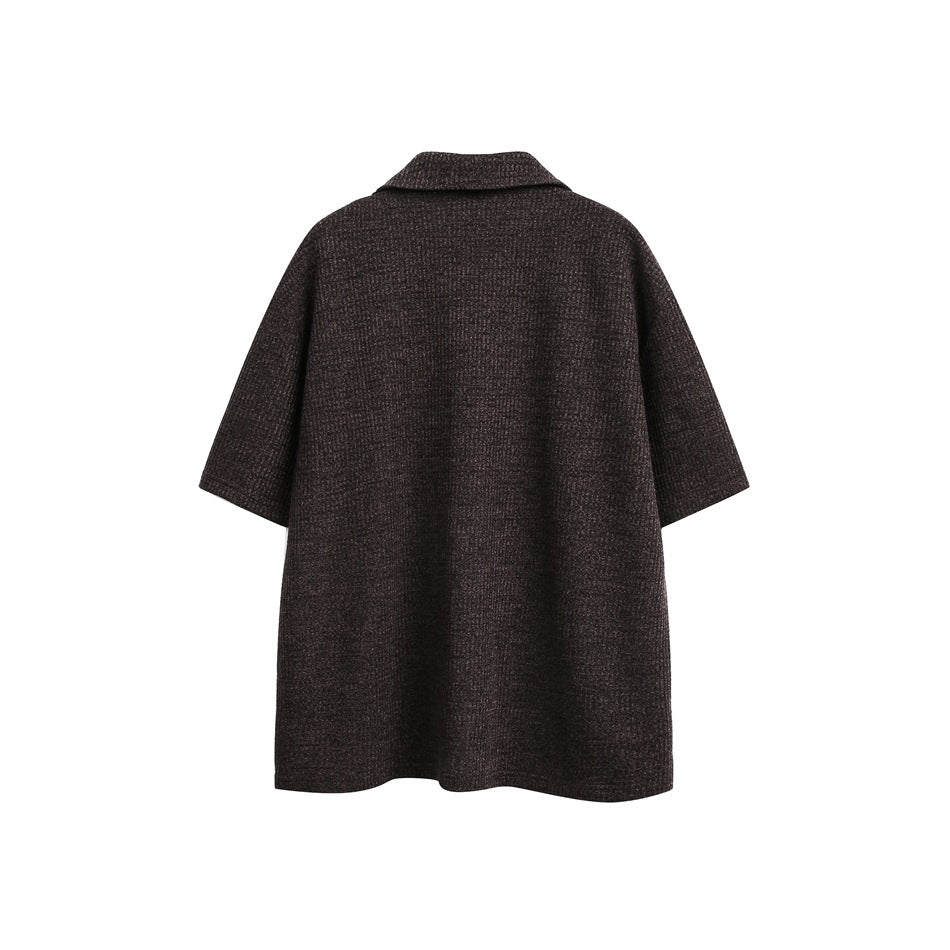 Back view of a dark brown textured, short-sleeved collared garment on a white background.