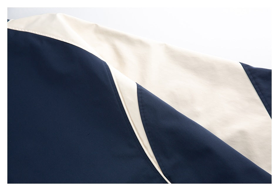 Close-up of navy and ivory garment panels with curved stitched seams.