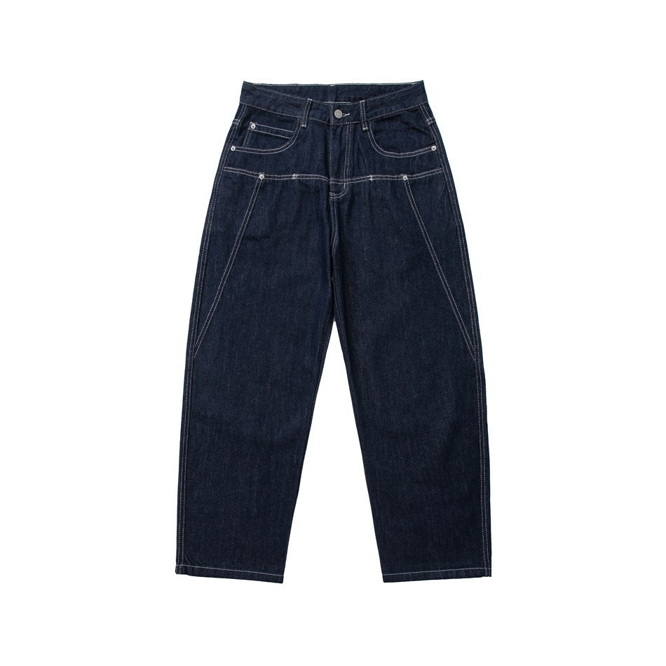 Front view of dark indigo wide straight-leg jeans with light contrast topstitching and angled seams on the legs