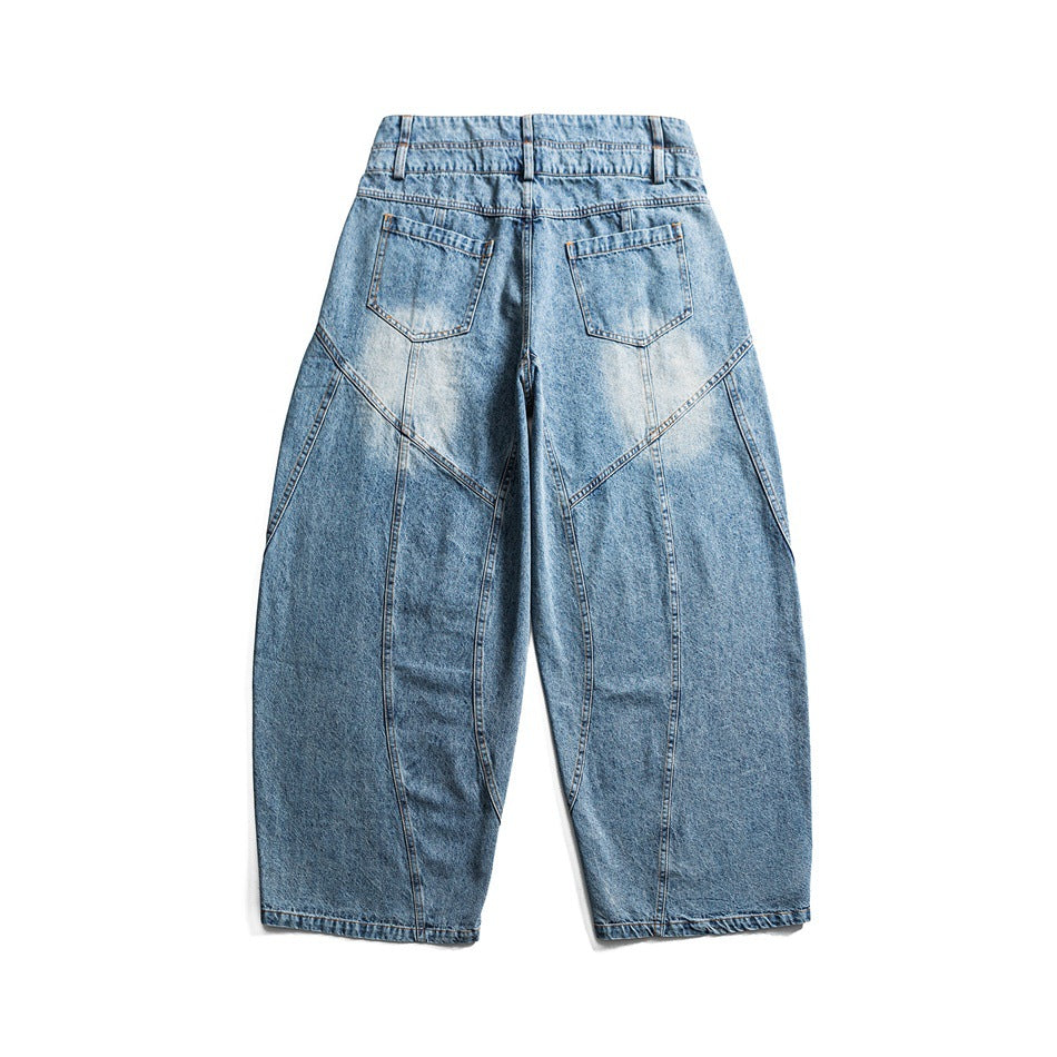 Back view of light blue wide-leg jeans with two patch pockets and curved panel seams.