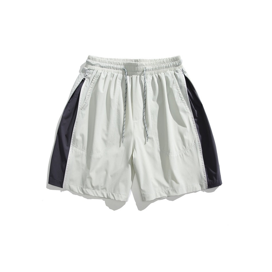 Light gray shorts with dark gray side panels, drawcord and zippered side pockets, flat lay