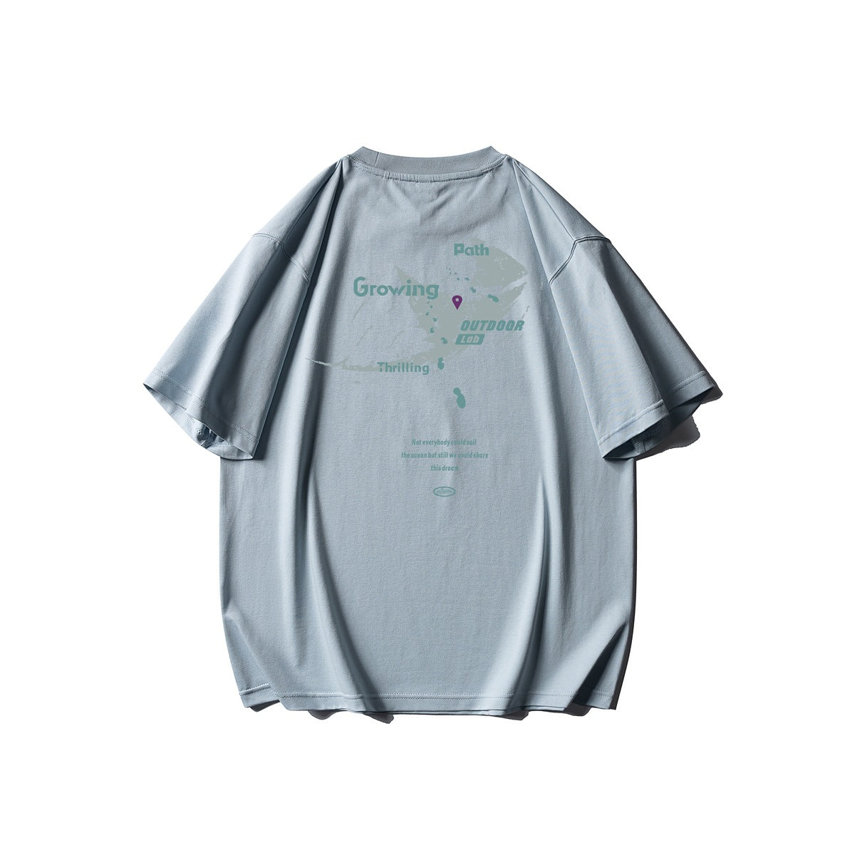 Back view of a pale blue oversized T-shirt with a subtle outdoor map graphic and English text.