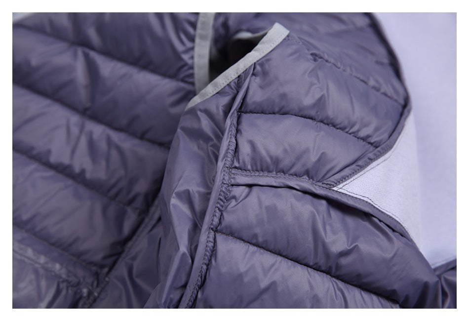 Close-up of a purple padded garment opening with stitched quilting and light gray edge trim.