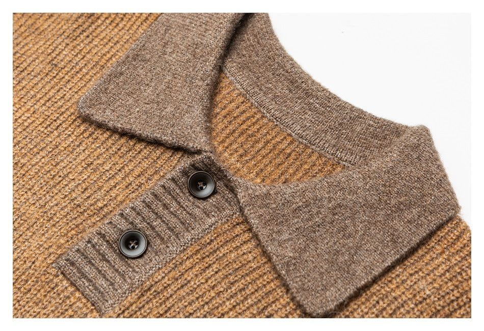 Close-up of a brown knit sweater's contrasting collar and two dark buttons.