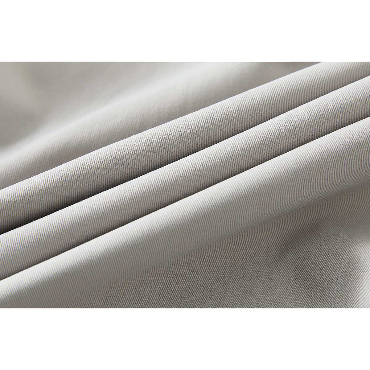 Close-up of light gray fabric folded into ridges, showing its fine diagonal weave.