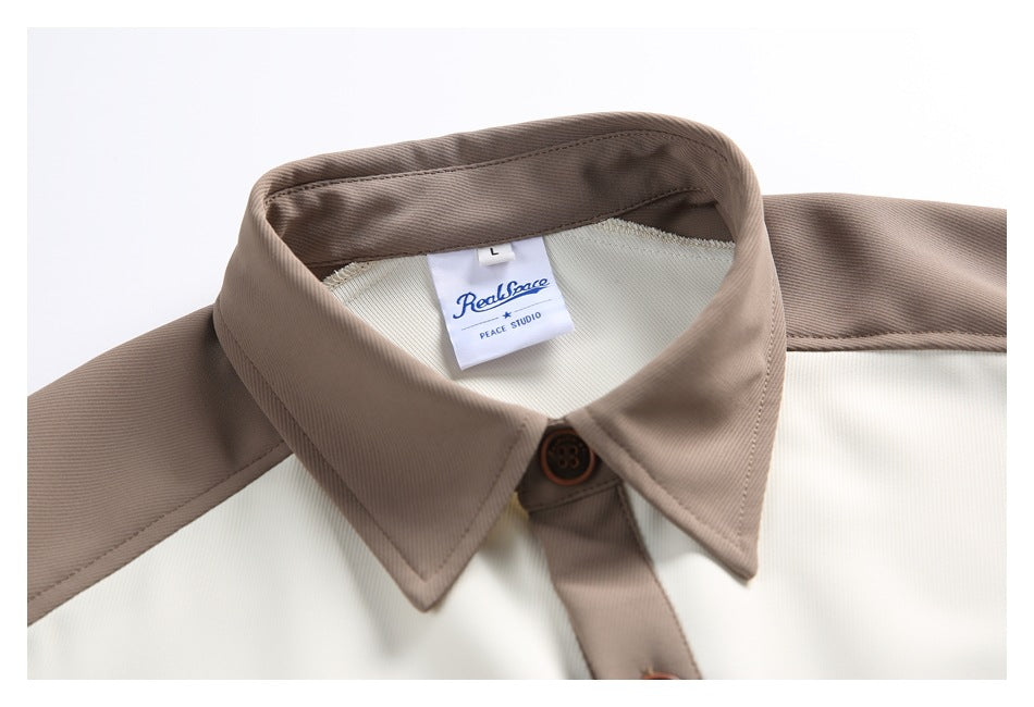 Close-up of the taupe shirt collar, brown button, and sewn neck label.