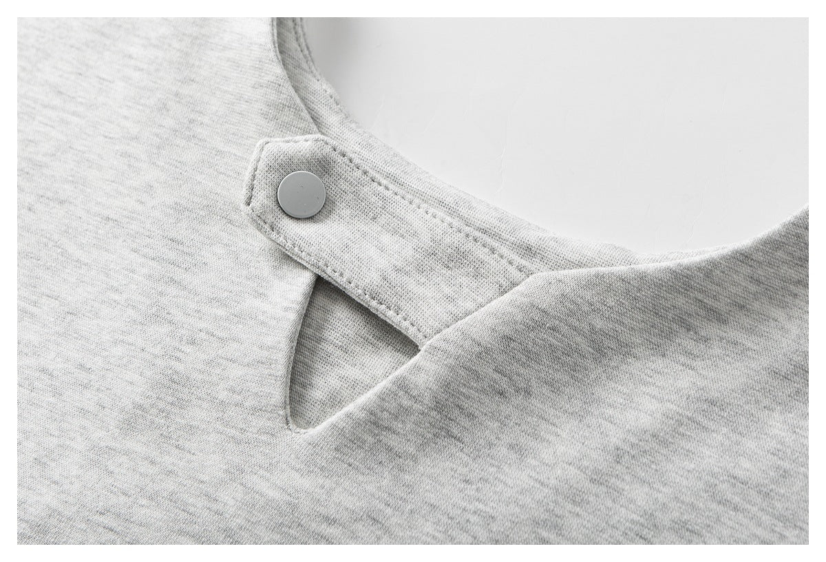 Close-up of a light gray heathered garment neckline with a round snap on a shoulder tab.