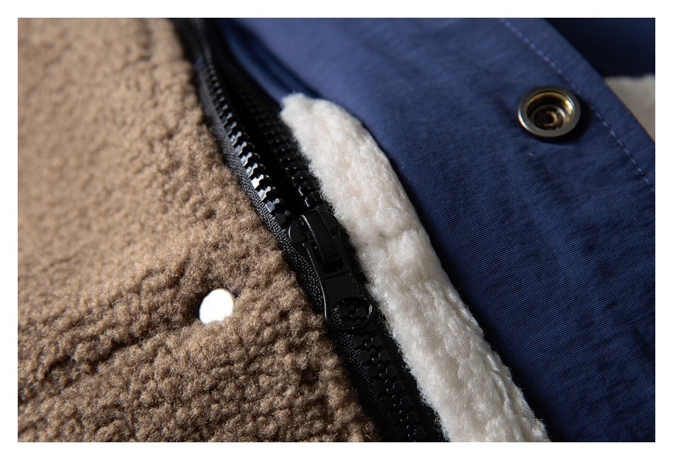 Close-up of a black zipper and snap fastening between brown fleece, white lining, and navy fabric.