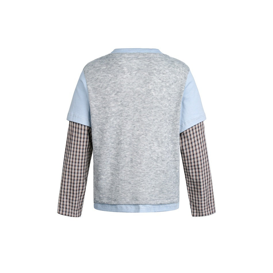 Back of a layered top with a heather-gray body, pale blue short sleeves, and brown plaid long sleeves.