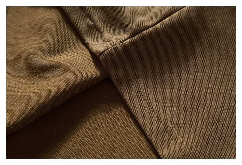 Close-up of brown polo fabric and intersecting stitched seams.