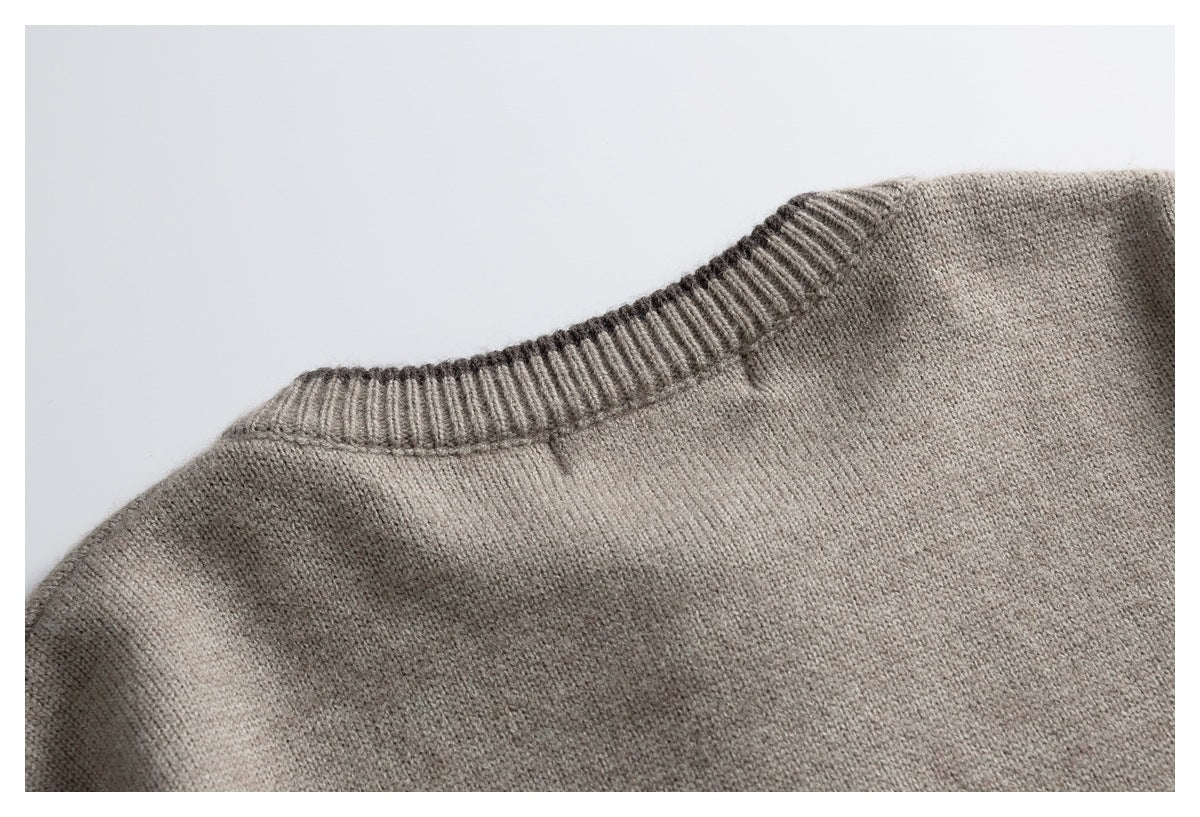 Close-up of the taupe cardigan’s ribbed crew neckline and shoulder seam.