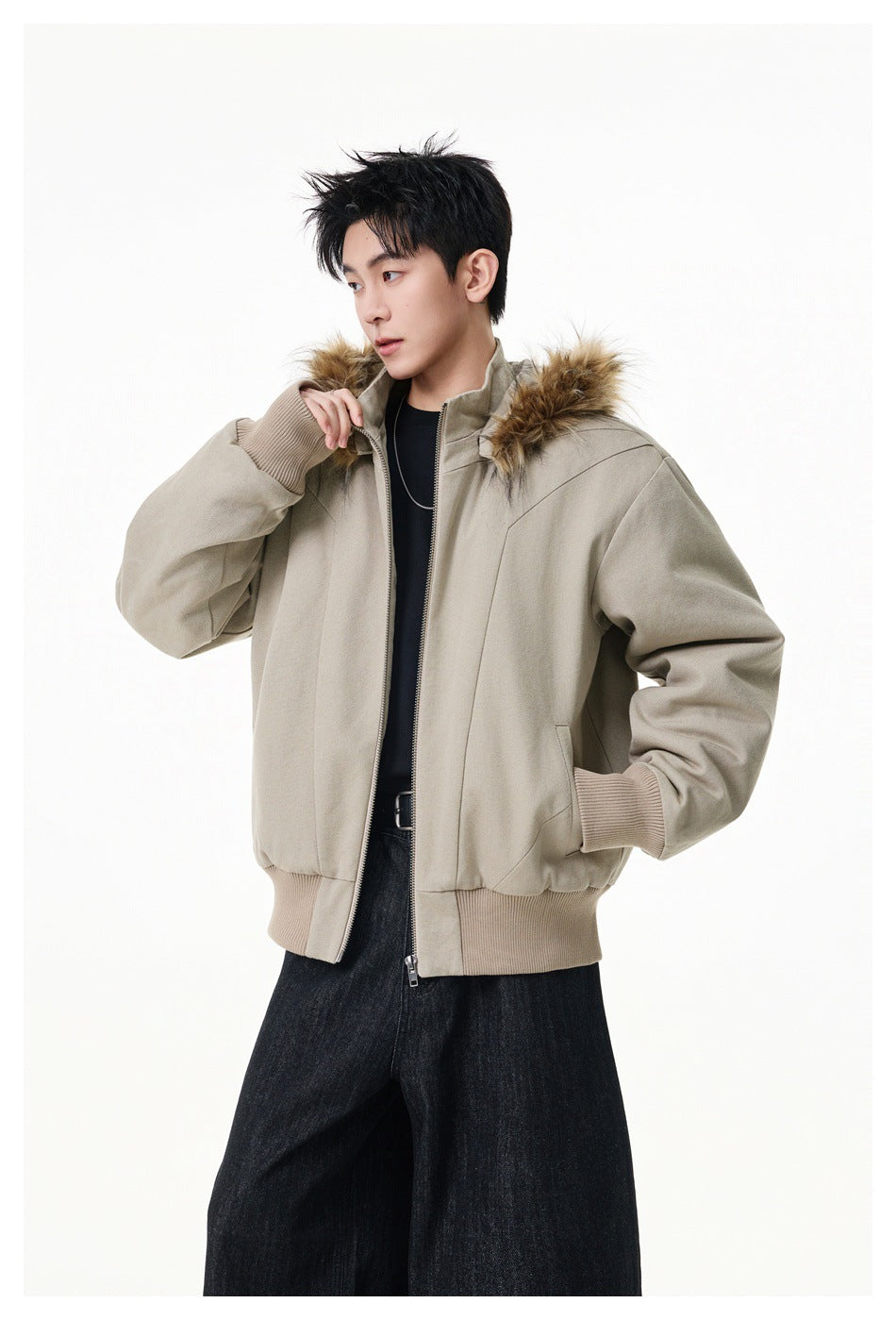 Model wearing a light taupe zip-up jacket with a brown fur-trimmed hood, ribbed cuffs and hem.