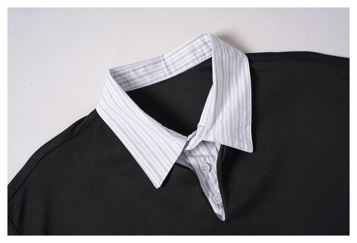 Close-up of a black textured shirt with a white, fine-striped pointed collar and button placket.