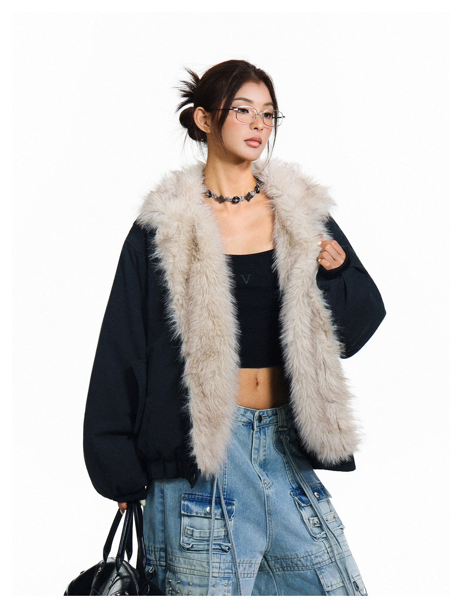 Model wearing an open black jacket with a long light-beige fur collar, shown with a black top and blue cargo jeans.
