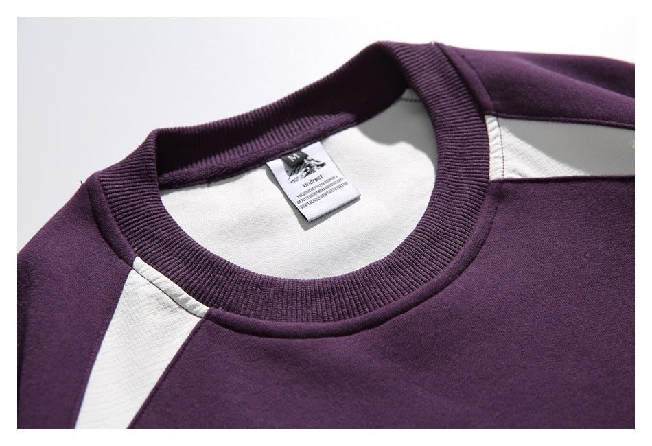 Close-up of the sweatshirt's ribbed crew neckline, white shoulder insert, and inner neck label.