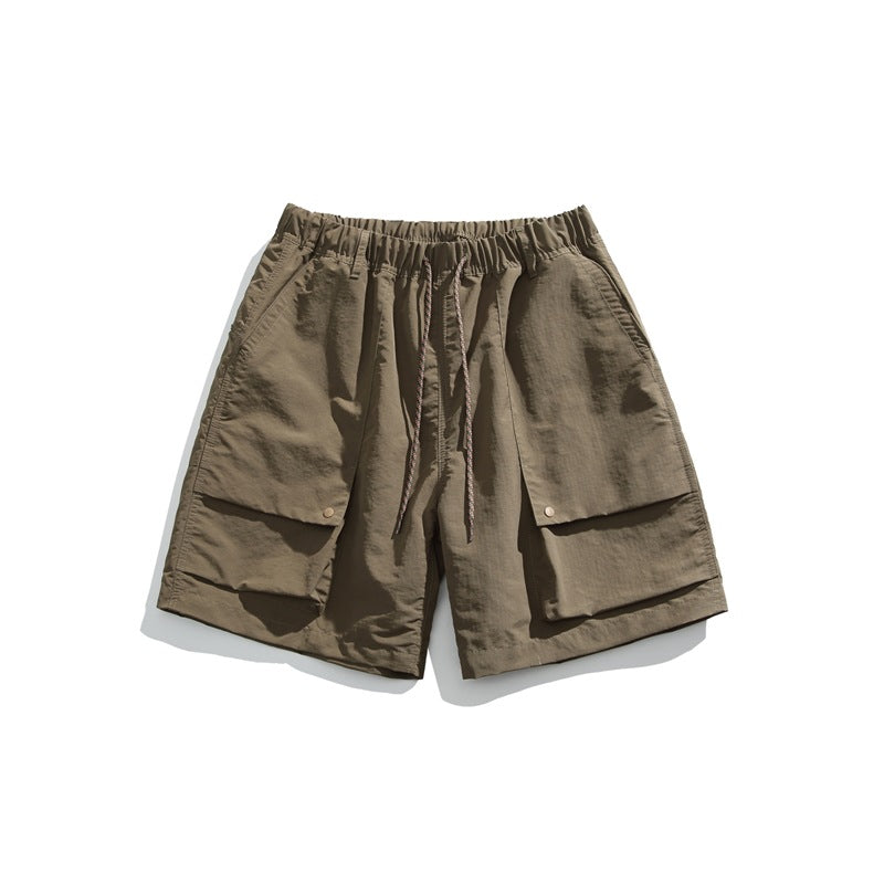 Dark khaki drawstring shorts with elastic waist and large front flap pockets, flat lay front view