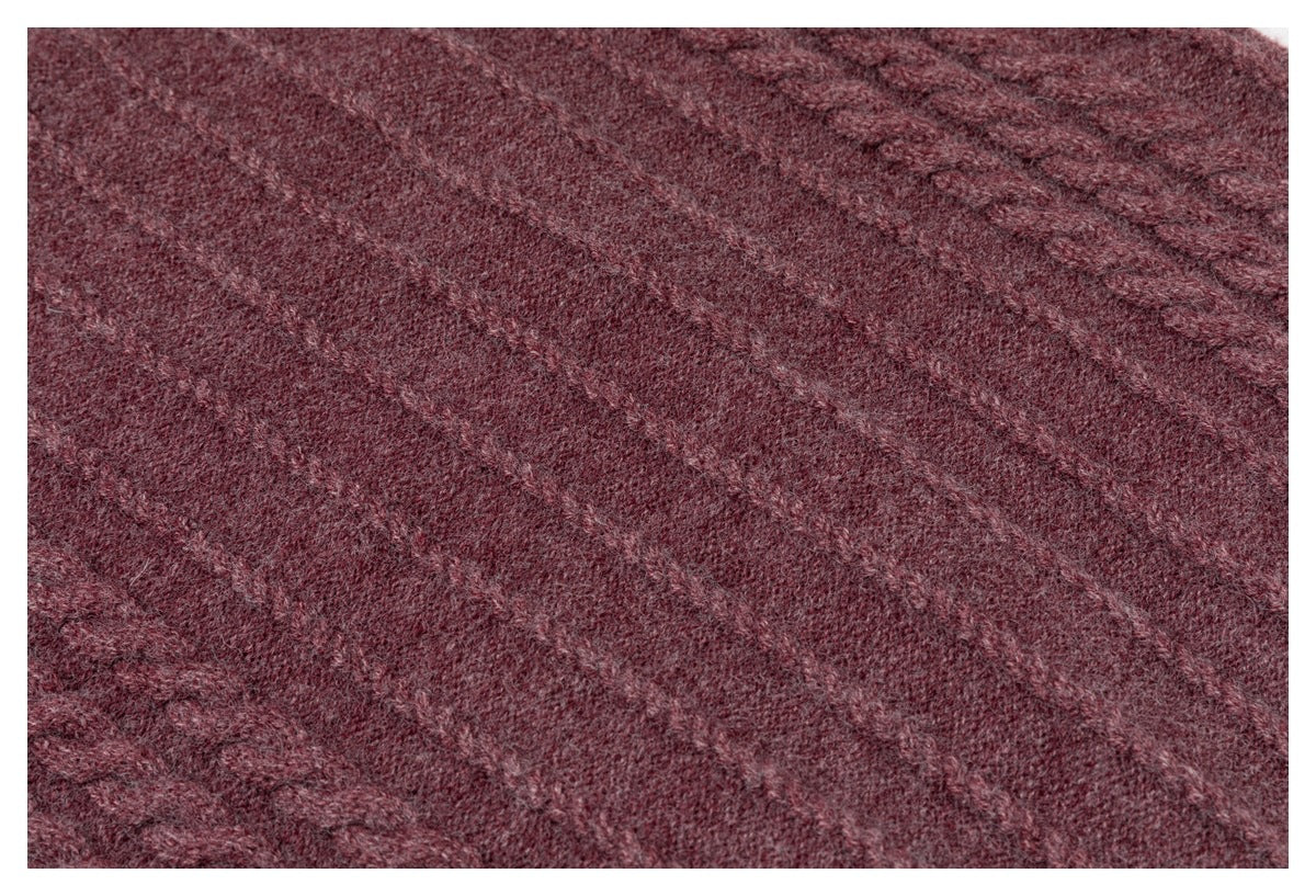 Close-up of the burgundy garment's softly textured knit surface.