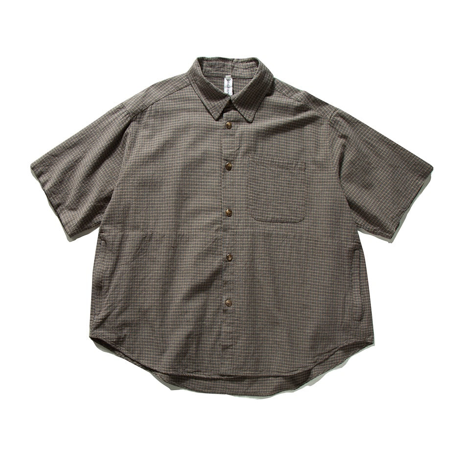 Brown micro-check short-sleeve button-up shirt with chest pocket and curved hem, flat front view