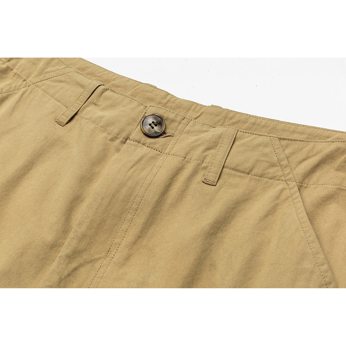 Close-up of tan shorts waistband with a button, belt loops, stitching and front seam.