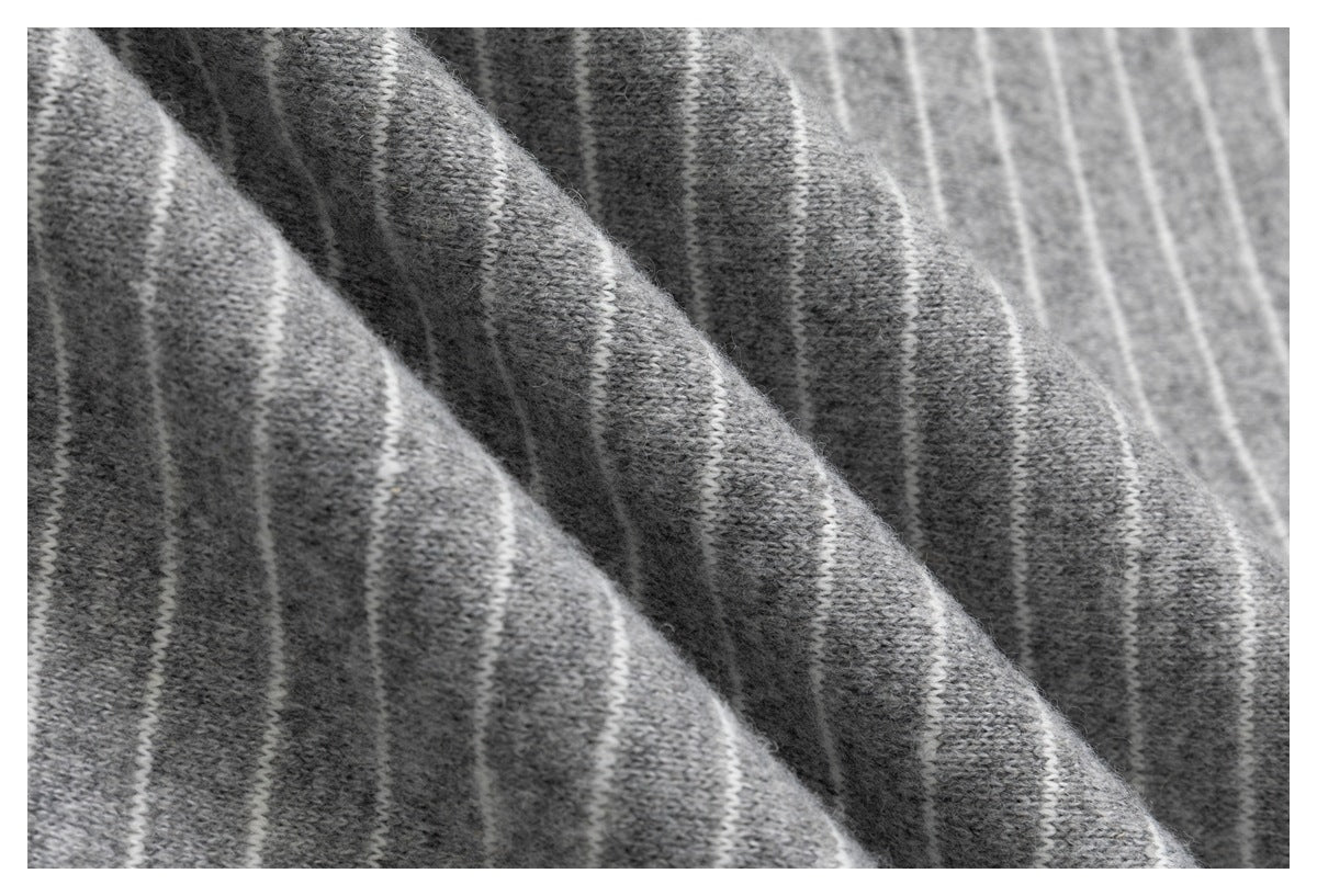 Macro view of the gray knit fabric with narrow white stripes.