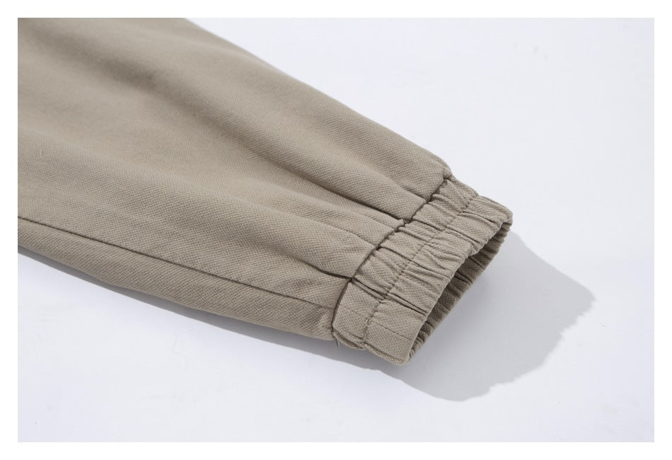 Close-up of the gathered elastic cuff on a tan jacket sleeve.